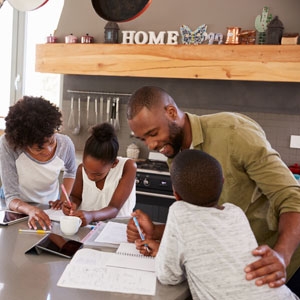 A couple with their children, who are studying, symbolizing the concept of parenting.